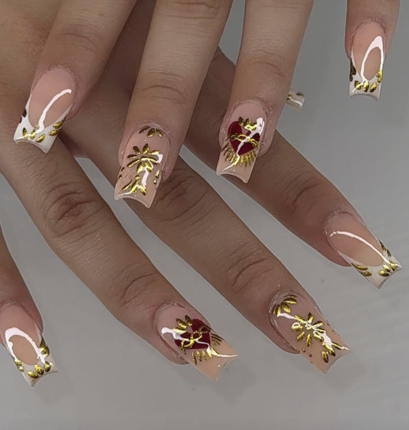 Long coffin nails with white French tips, gold foil floral art and red heart accents